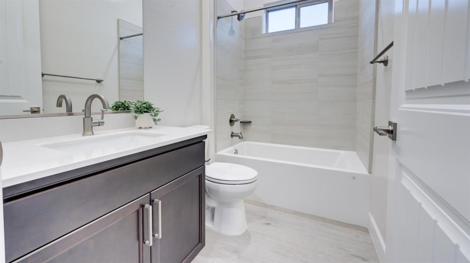 935 Talus Way Madera, CA 93636 - Photo 13 of 34 a bathroom with a sink a toilet and a mirror