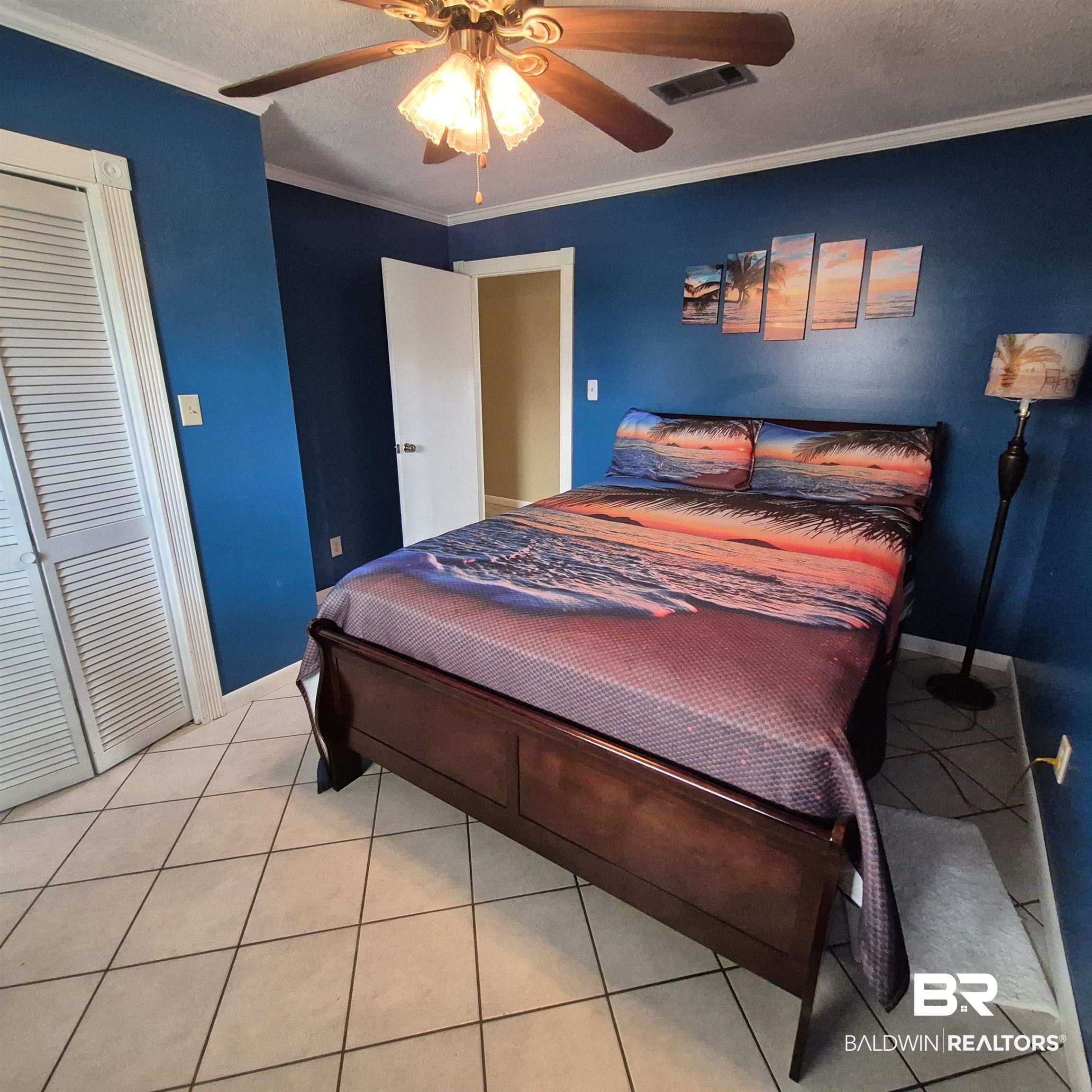 26635 Highway 41 Range, AL 36473 - Photo 31 of 74 Bedroom featuring ornamental molding, a ceiling fan, light tile patterned flooring, a textured ceiling, and a closet