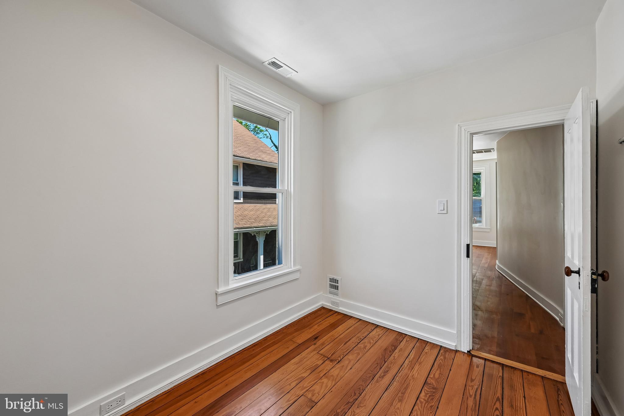 5702 Falls Road Baltimore, MD 21209 - Photo 31 of 49 wooden floor in an empty room with a window