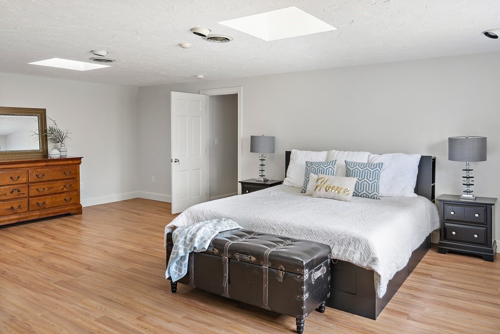 2 Partridge Hill Road Dover, MA 02030 - Photo 13 of 26 a spacious bedroom with a bed and wooden floor