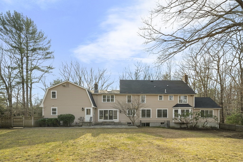 2 Partridge Hill Road Dover, MA 02030 - Photo 2 of 26 a front view of a house with a yard covered with snow