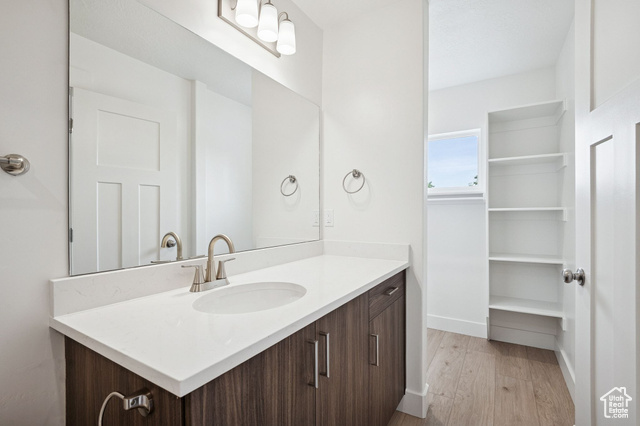 1615 North Angel Street, Unit H Layton, UT 84041 - Photo 31 of 55 Bathroom with vanity, light wood finished floors, and a spacious closet