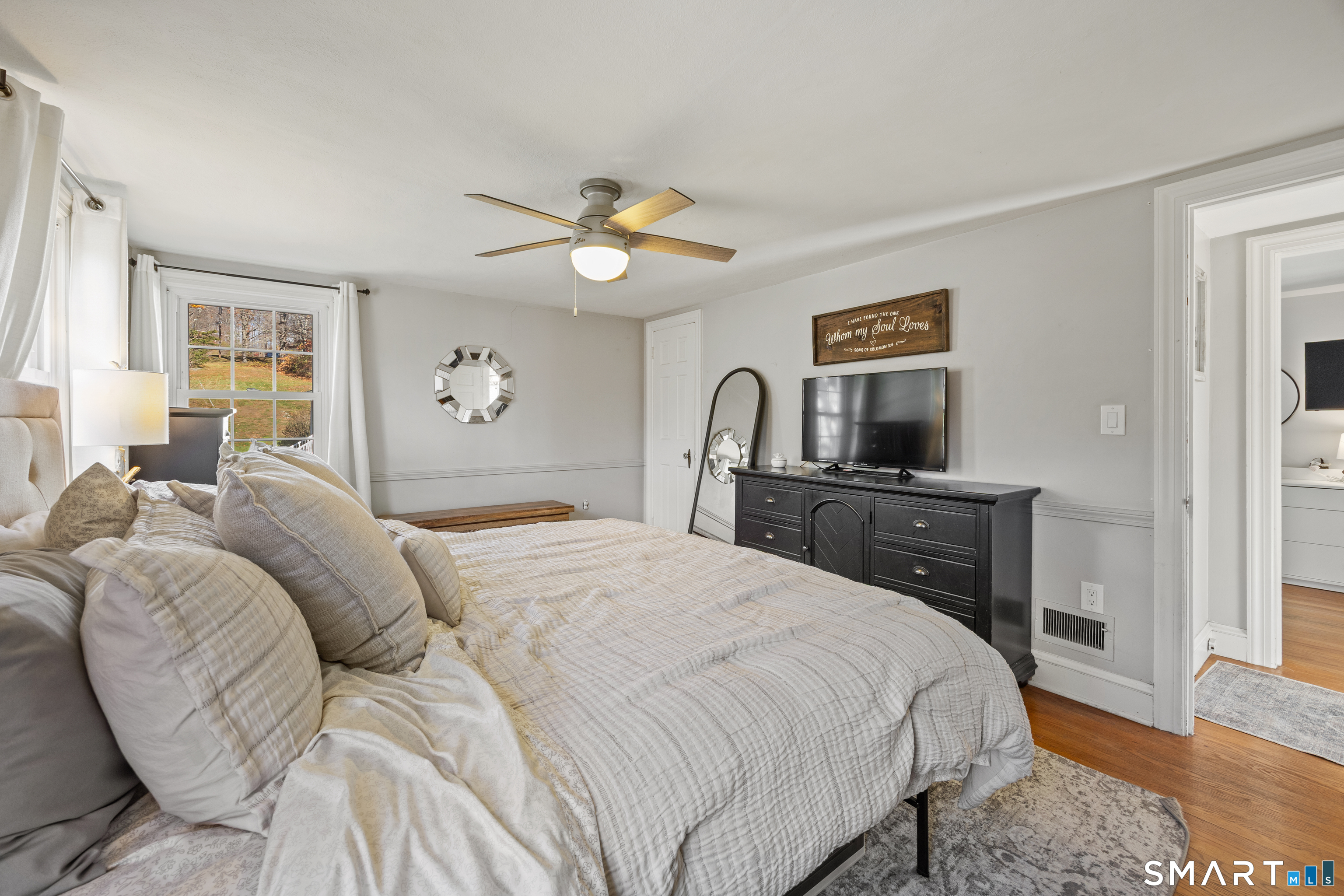 232 High Street Thomaston, CT 06787 - Photo 20 of 31 a bedroom with a bed and a chandelier