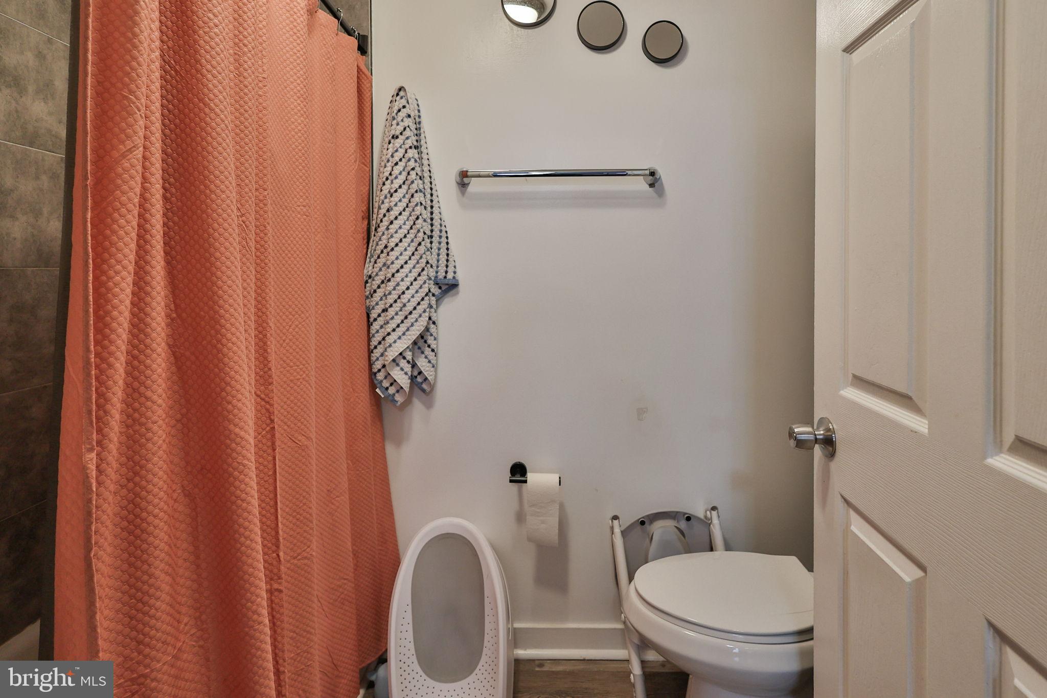 714 Ward Street Chester, PA 19013 - Photo 12 of 40 a bathroom with a toilet and a shower curtain