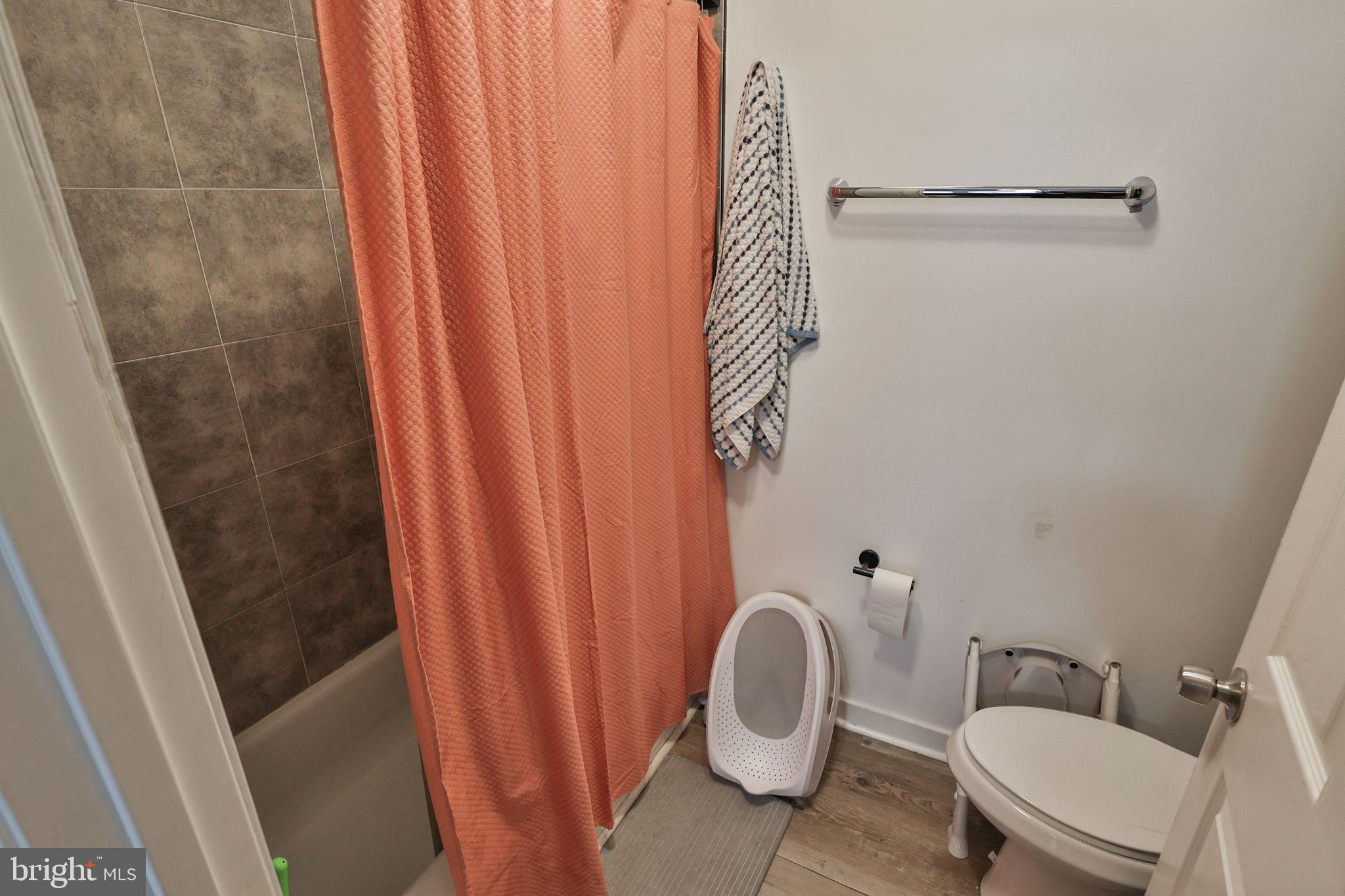 714 Ward Street Chester, PA 19013 - Photo 13 of 40 a white toilet sitting next to a shower