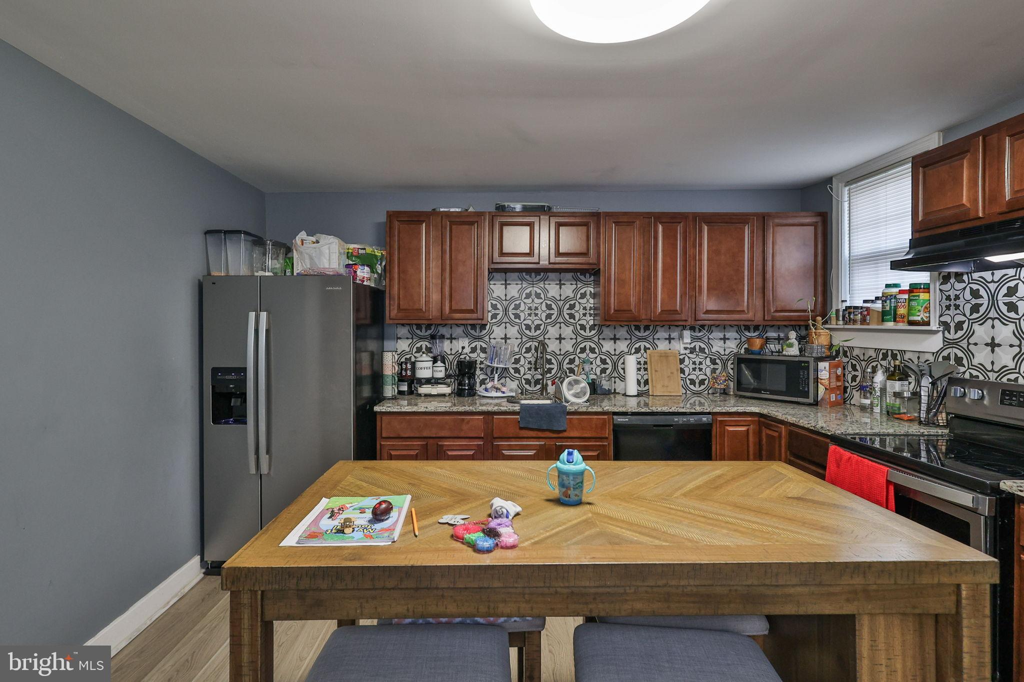 714 Ward Street Chester, PA 19013 - Photo 18 of 40 a kitchen with kitchen island a sink stove and refrigerator