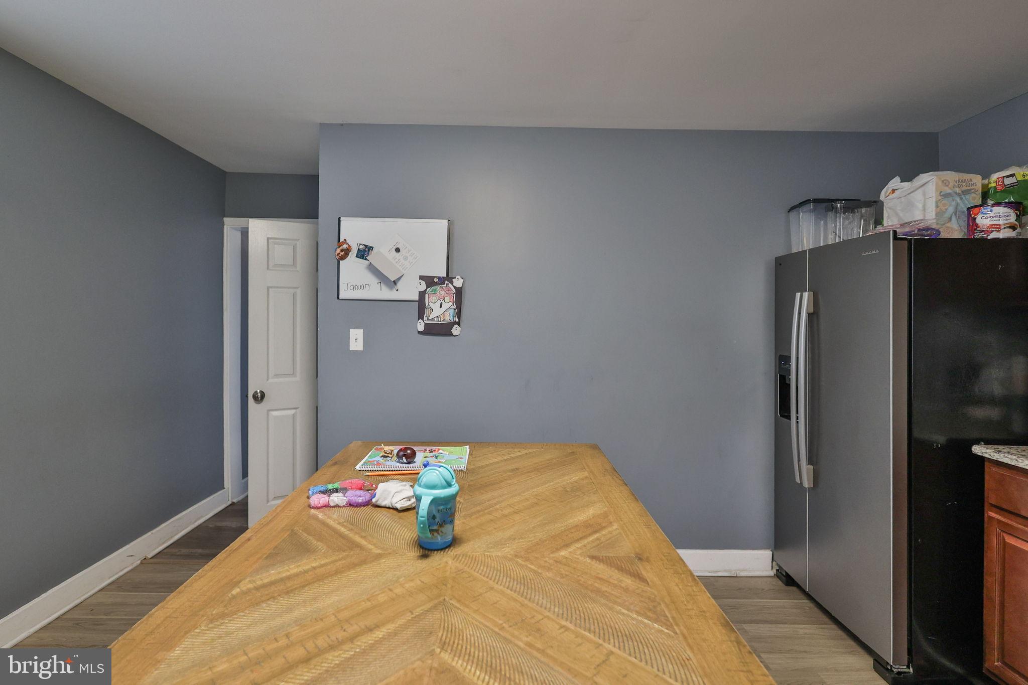 714 Ward Street Chester, PA 19013 - Photo 20 of 40 a bedroom with a bed and a refrigerator