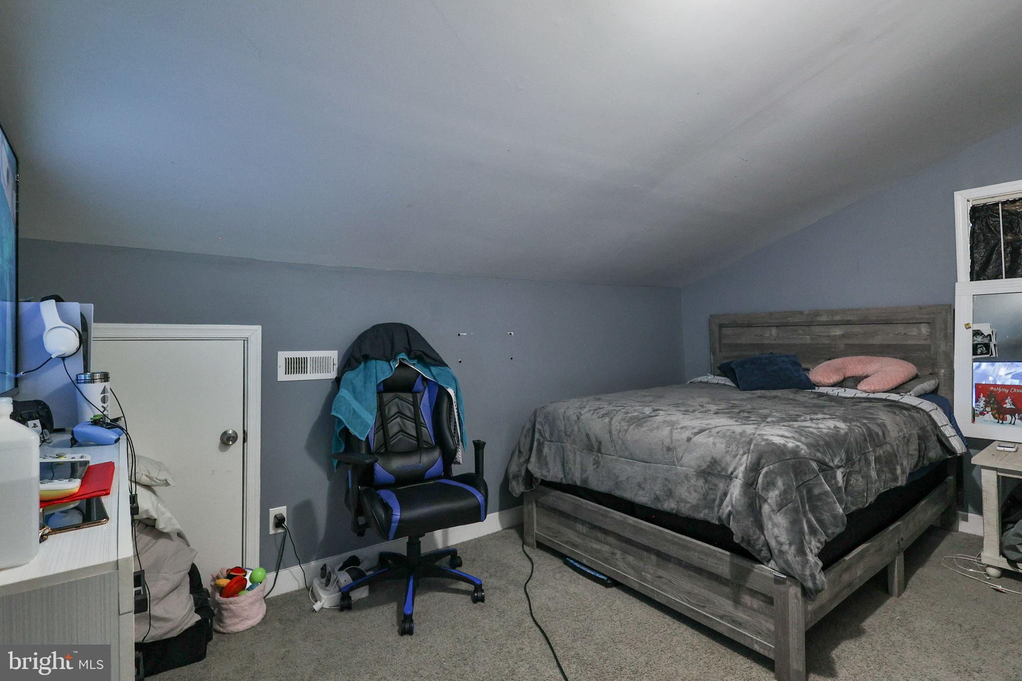 714 Ward Street Chester, PA 19013 - Photo 26 of 40 a bed sitting in a room next to a window