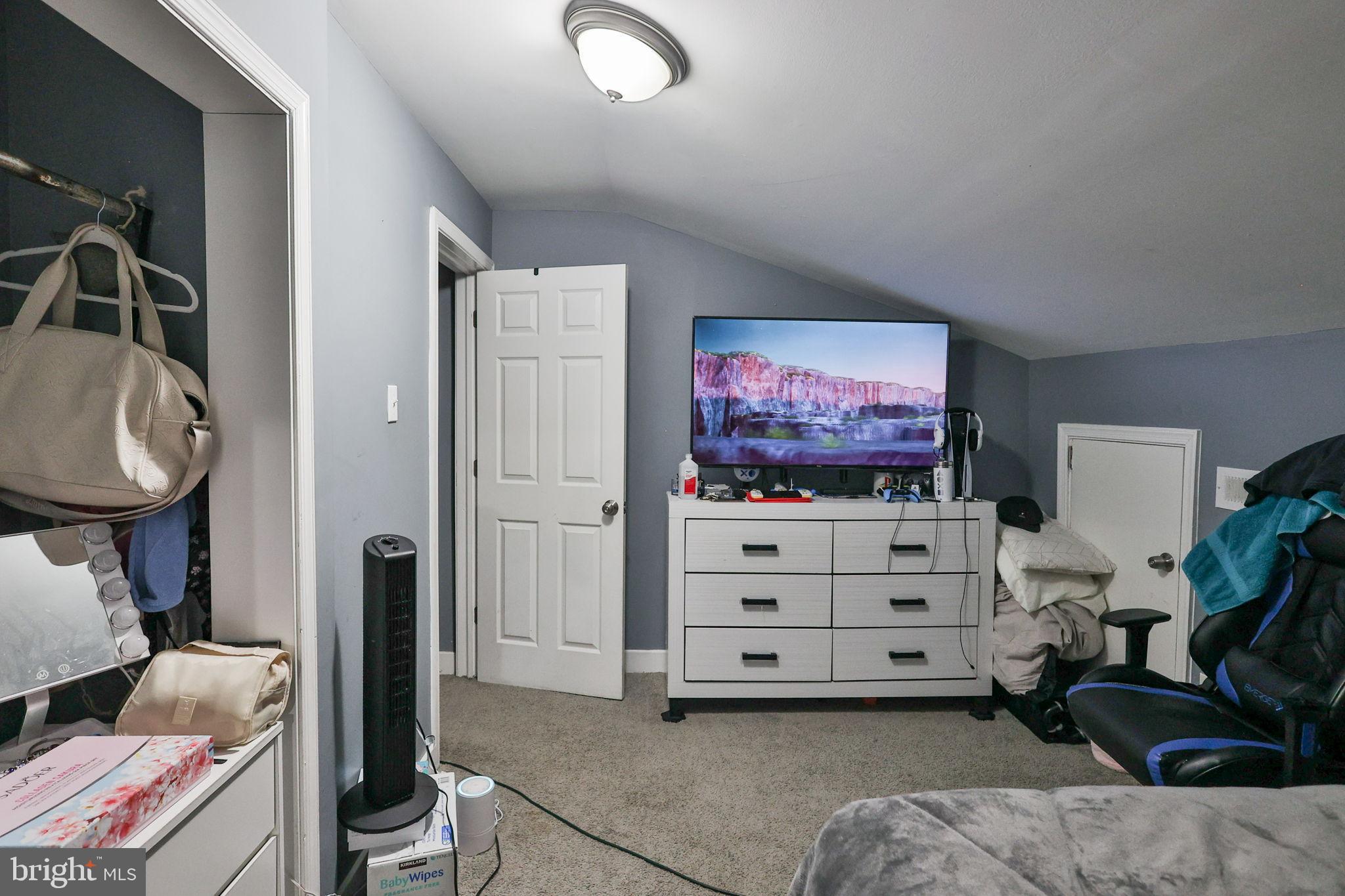 714 Ward Street Chester, PA 19013 - Photo 29 of 40 a living room with furniture a flat screen tv and gym equipment