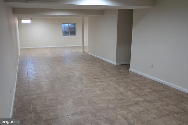 an empty room with a empty space and windows