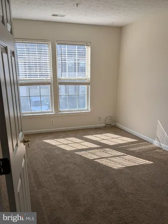 a view of a livingroom with an empty space and window