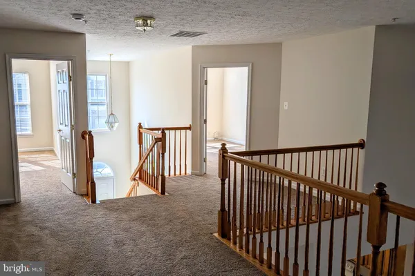 a view of a hallway with hallway and wooden floor