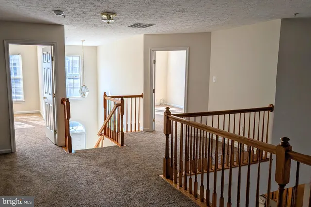 a view of a hallway with hallway and wooden floor