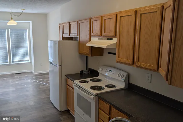 a kitchen with a sink a stove and cabinets