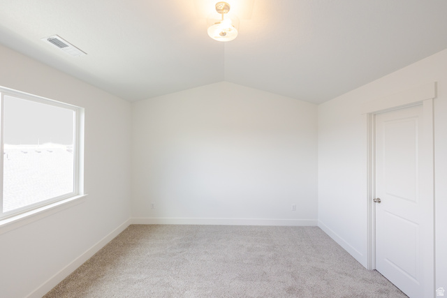 4816 Heartwood Road, Unit 423 Mapleton, UT 84664 - Photo 15 of 21 Unfurnished room with vaulted ceiling and light colored carpet