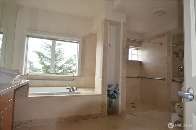 a bathroom with a bathtub and a shower