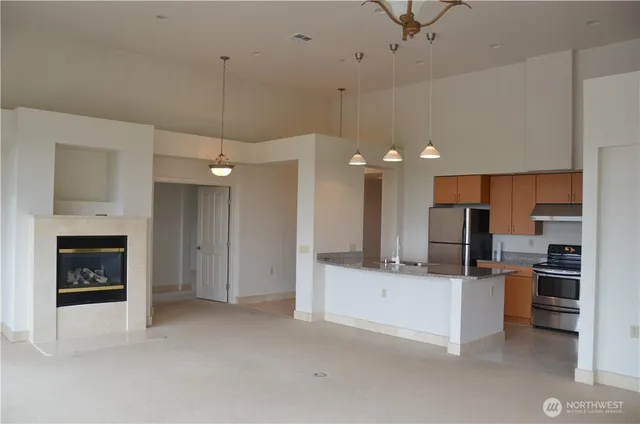 a kitchen with kitchen island a sink stainless steel appliances and cabinets