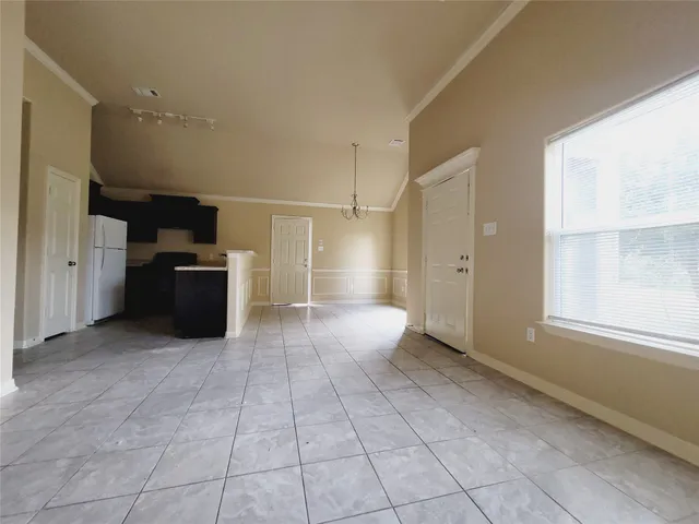 a view of a refrigerator and window in a room