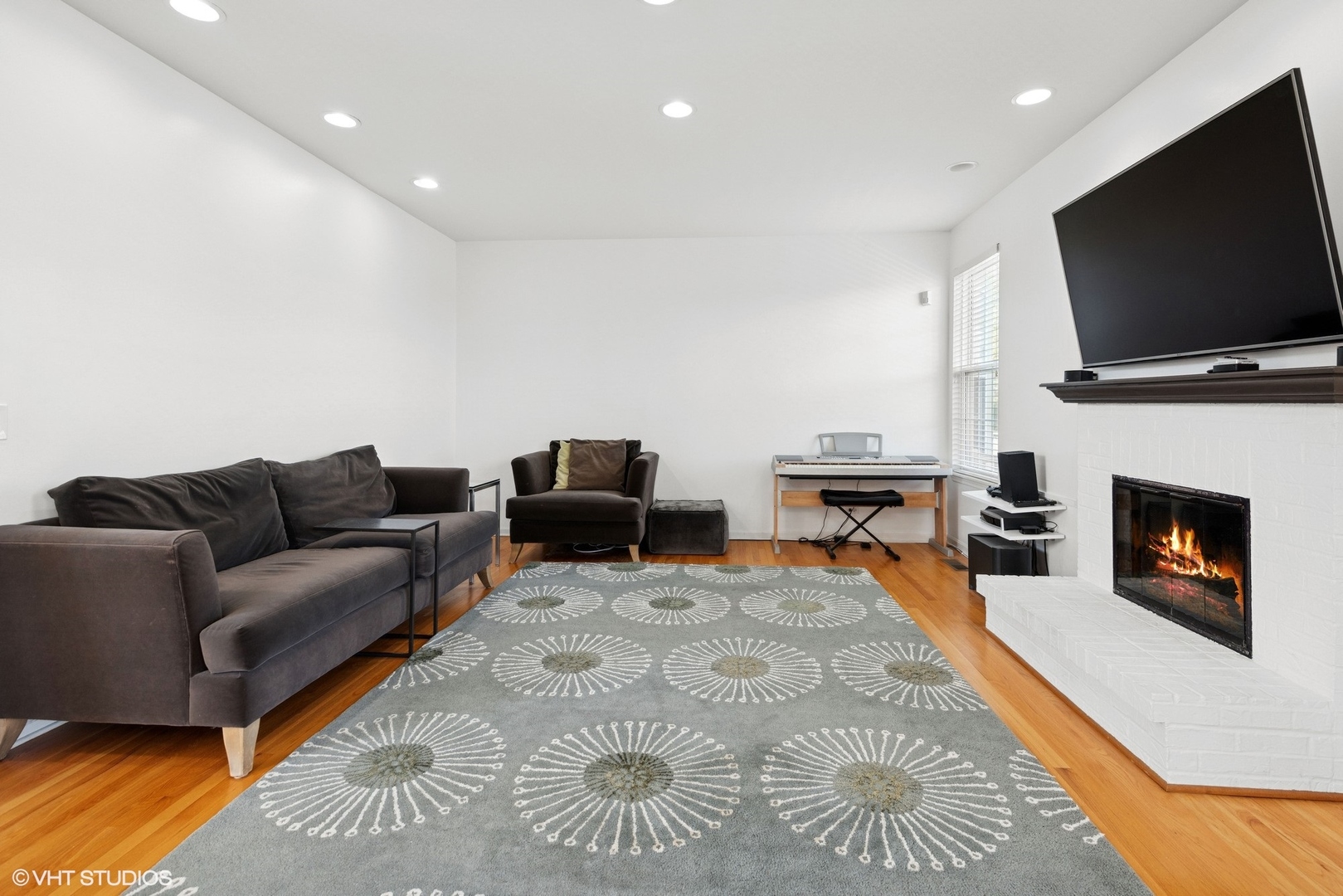 62 Andover Circle Northbrook, IL 60062 - Photo 9 of 23 a living room with furniture a flat screen tv and a fireplace