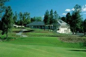 a view of house with a yard