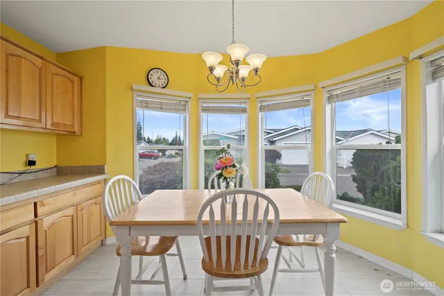 a kitchen with stainless steel appliances a sink cabinets and a window