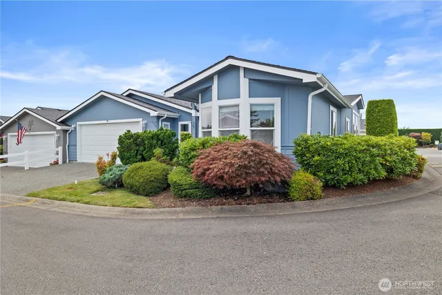a front view of a house with a yard and a garage