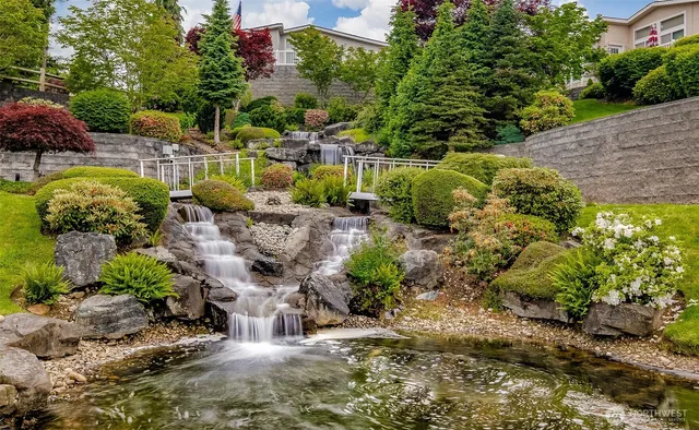 a view of residential houses with outdoor space and lake view