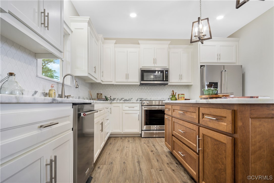 767 Sunken Meadow Road Spring Grove, VA 23881 - Photo 11 of 39 a kitchen with kitchen island granite countertop a sink cabinets and stainless steel appliances
