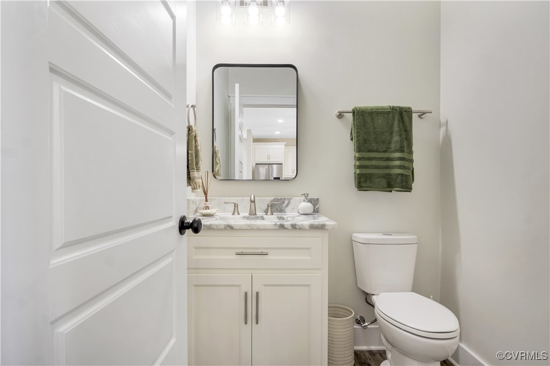 767 Sunken Meadow Road Spring Grove, VA 23881 - Photo 13 of 39 a bathroom with a toilet a sink a vanity and mirror