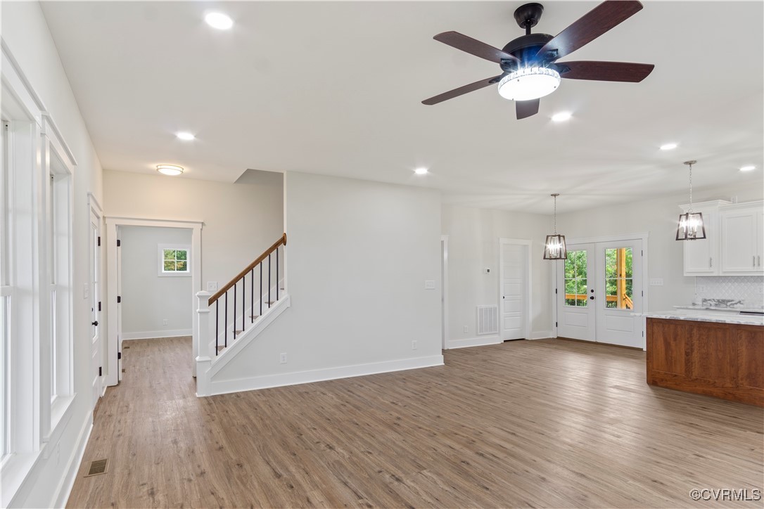 767 Sunken Meadow Road Spring Grove, VA 23881 - Photo 17 of 39 an empty room with wooden floor and windows