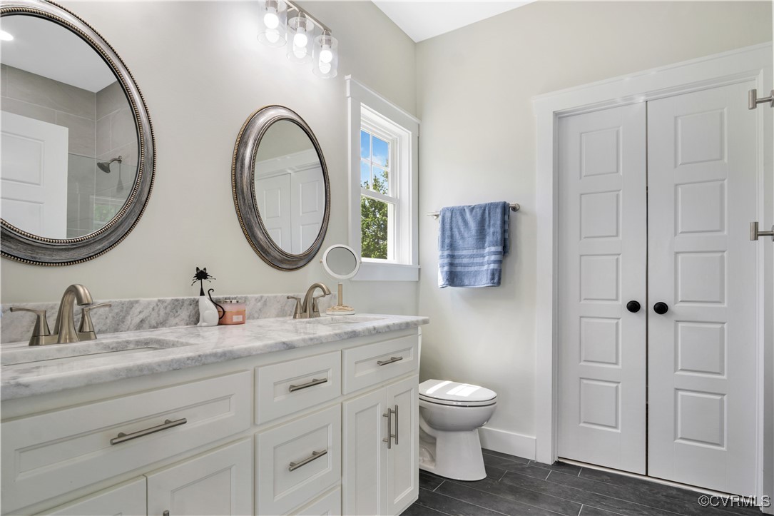 767 Sunken Meadow Road Spring Grove, VA 23881 - Photo 19 of 39 a bathroom with a double vanity sink and a mirror