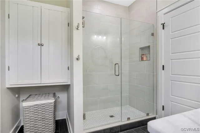 a bathroom with a toilet and a shower