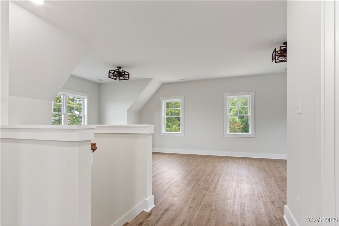 767 Sunken Meadow Road Spring Grove, VA 23881 - Photo 26 of 39 wooden floor in an empty room with a window