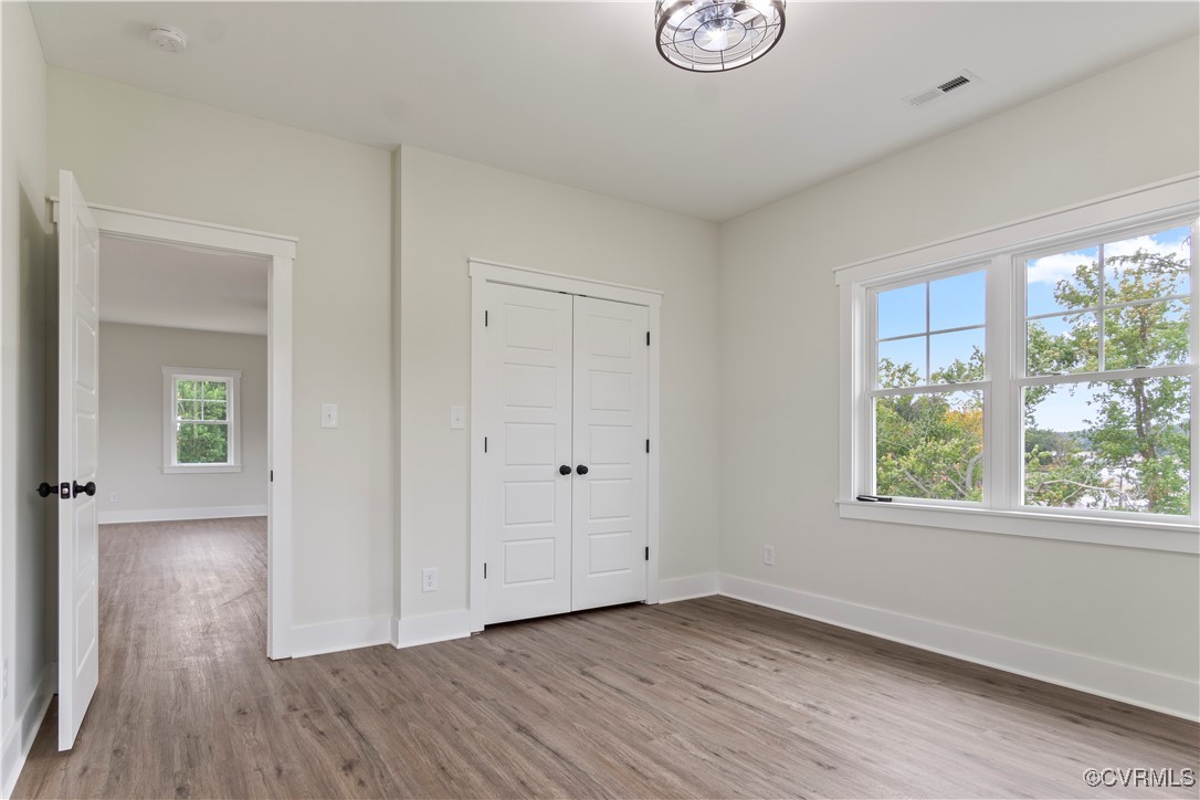 767 Sunken Meadow Road Spring Grove, VA 23881 - Photo 30 of 39 a view of an empty room with wooden floor and a window