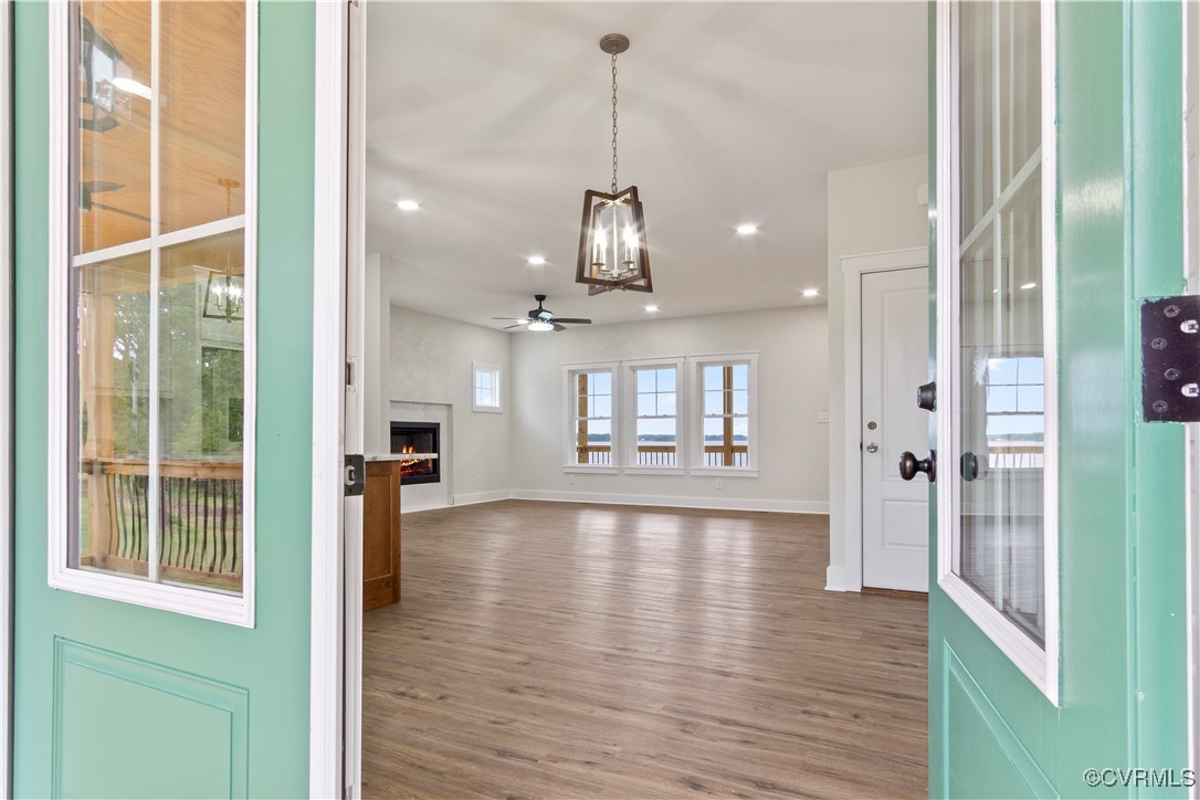 767 Sunken Meadow Road Spring Grove, VA 23881 - Photo 8 of 39 a view of a kitchen and a chandelier wooden floor and windows