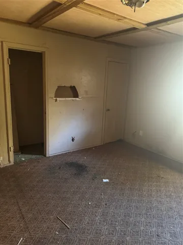 a view of an empty room with windows