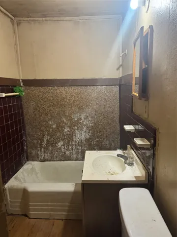 a view of a bathroom from a hallway