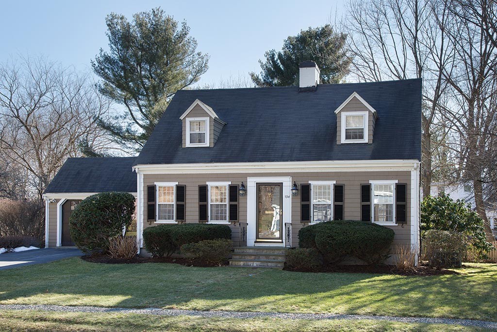 134 Annawan Road Newton, MA 02468 - Photo 1 of 8 a view of a brick house with a yard plants and large tree
