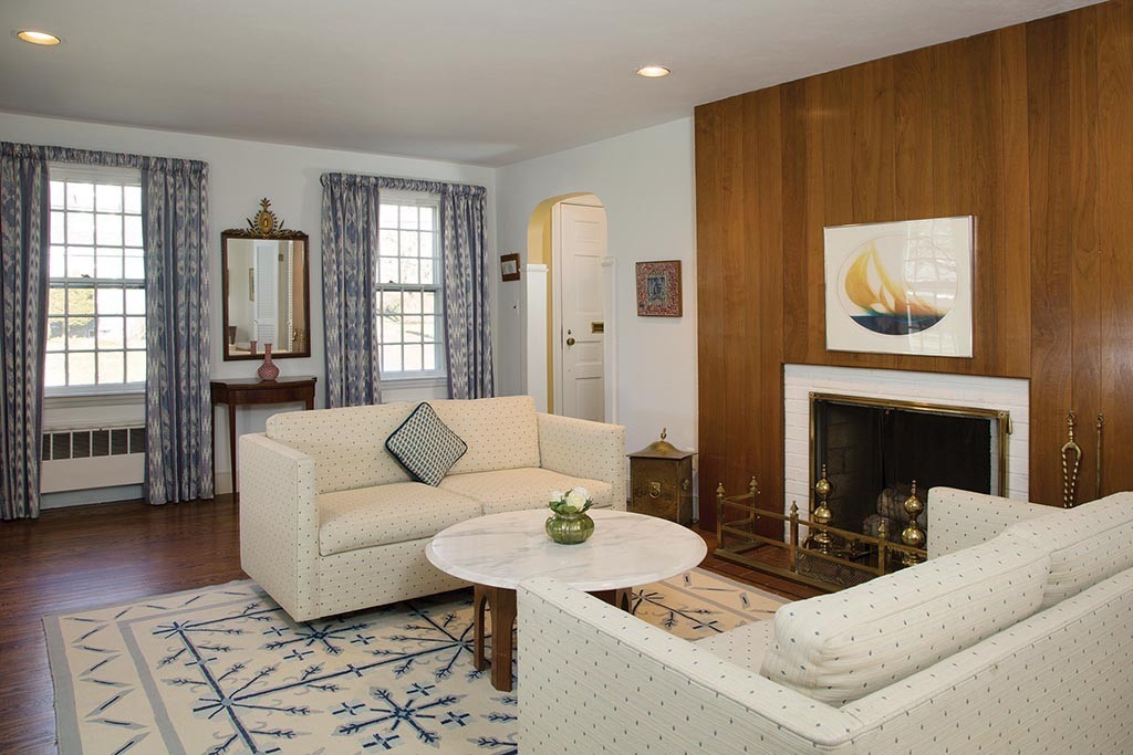 134 Annawan Road Newton, MA 02468 - Photo 2 of 8 a living room with furniture and a fireplace