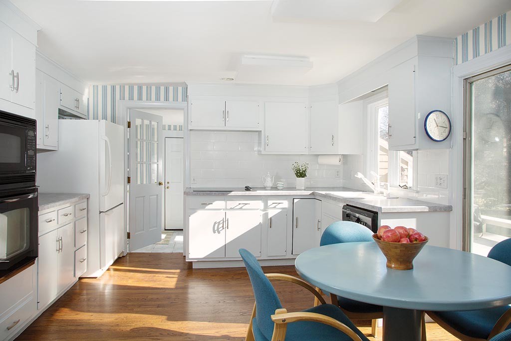 134 Annawan Road Newton, MA 02468 - Photo 4 of 8 a open kitchen with stainless steel appliances granite countertop a dining table chairs refrigerator and sink