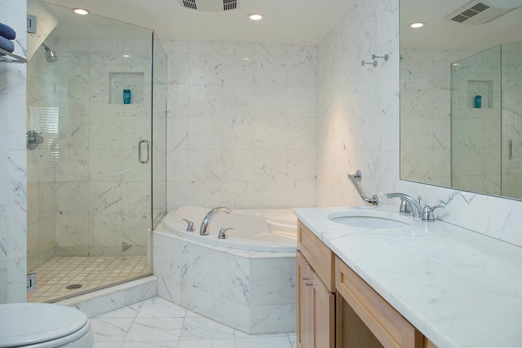 134 Annawan Road Newton, MA 02468 - Photo 7 of 8 a bathroom with a granite countertop sink a toilet and shower