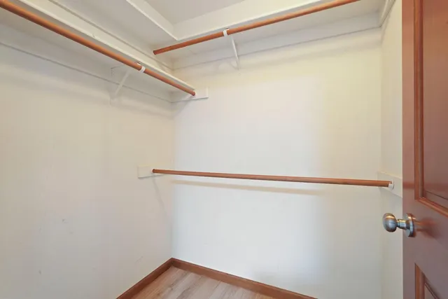 a view of a room with wooden floor and gate