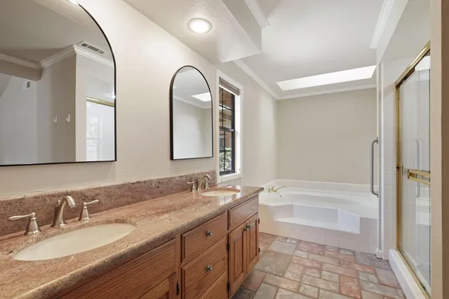 a bathroom with a double vanity sink and a mirror