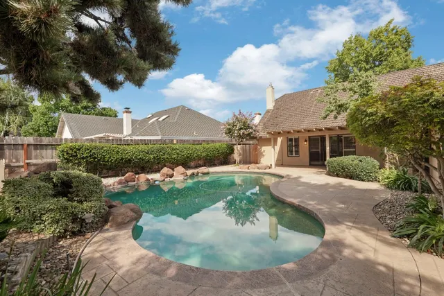 a view of a porch with a table and chairs