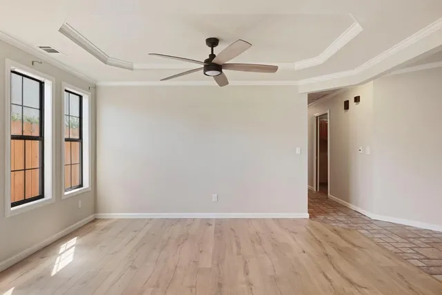 wooden floor in an empty room with a window