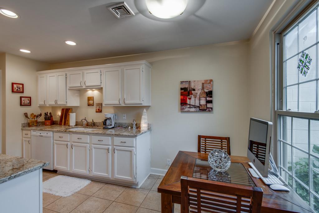 1056 General George Patton Road, Unit 1056 Nashville, TN 37221 - Photo 11 of 30 a kitchen with a cabinets and chairs