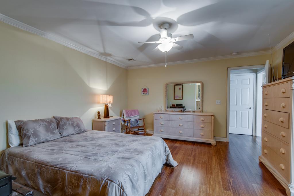 1056 General George Patton Road, Unit 1056 Nashville, TN 37221 - Photo 18 of 30 a bed room with furniture and wooden floor