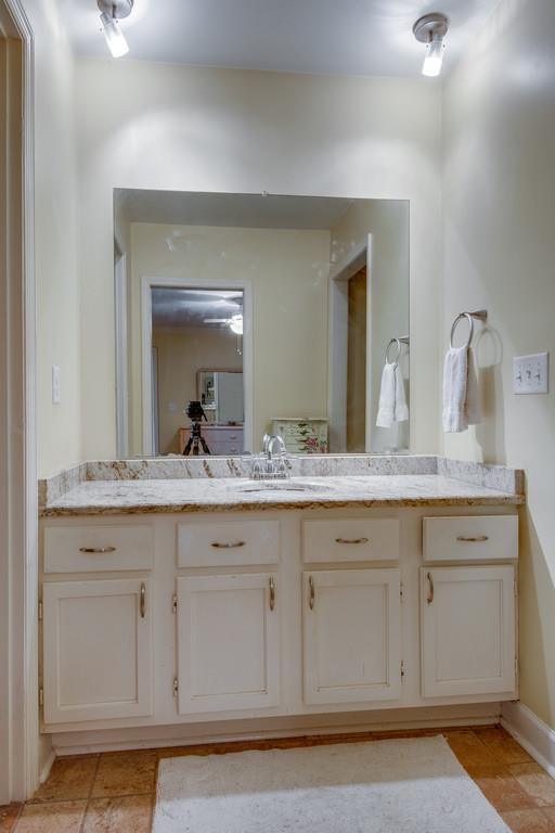1056 General George Patton Road, Unit 1056 Nashville, TN 37221 - Photo 19 of 30 a bathroom with a granite countertop sink and a mirror