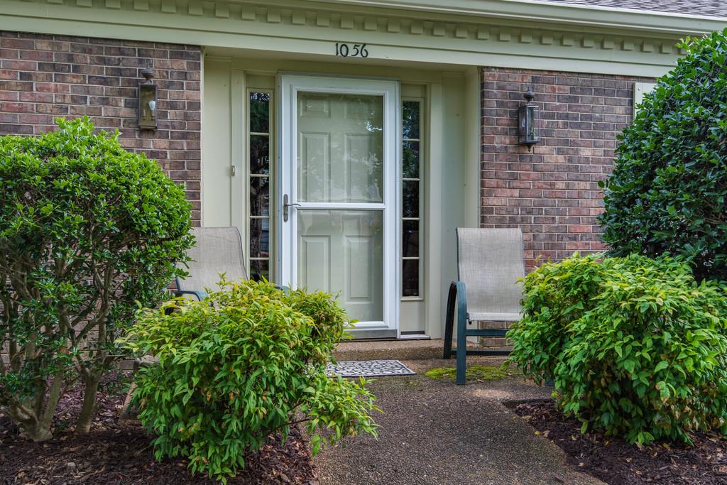 1056 General George Patton Road, Unit 1056 Nashville, TN 37221 - Photo 3 of 30 a view of a brick house with a yard and plants