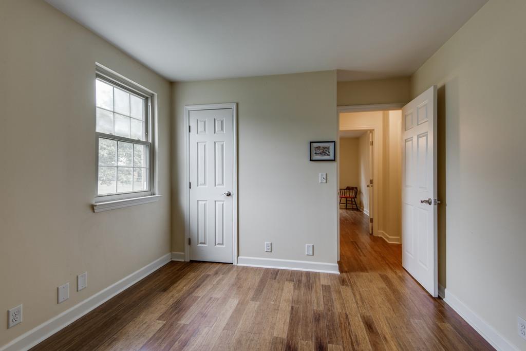 1056 General George Patton Road, Unit 1056 Nashville, TN 37221 - Photo 22 of 30 an empty room with wooden floor and windows